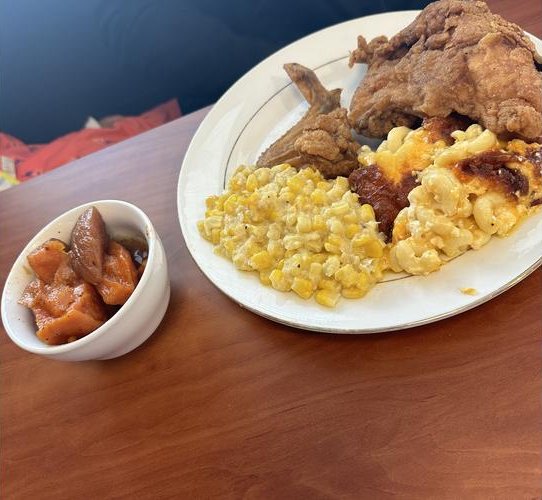 Fried chicken with creamed corn, mac and cheese and candied yams