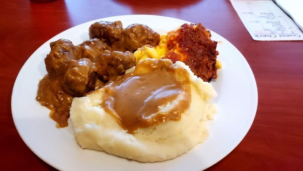 Meatballs in gravy over mashed potatoes